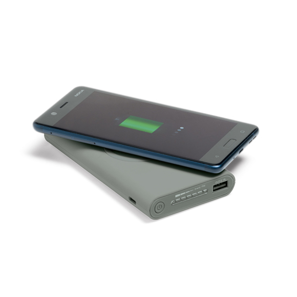 Grey wireless power bank charging a phone without a cable