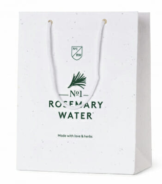 white rope handle bag with green logo to the front