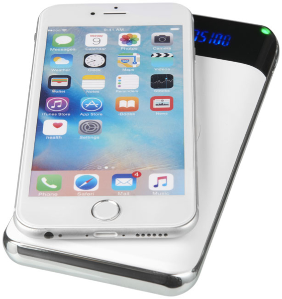 White power bank wirelessly charging a phone
