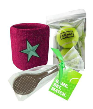 a chocolate cricket bat, 2 tennis balls and a pink sweatband