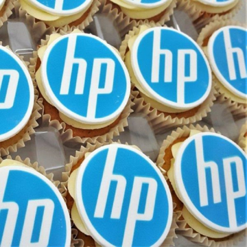 Iced cupcakes with personalised toppers printed with a company logo