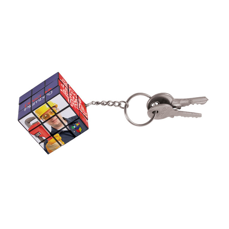a 3x3 square rubiks cube with a keychain connected to a set of keys