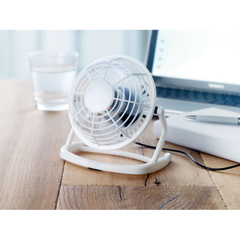 white mini fan on a desk