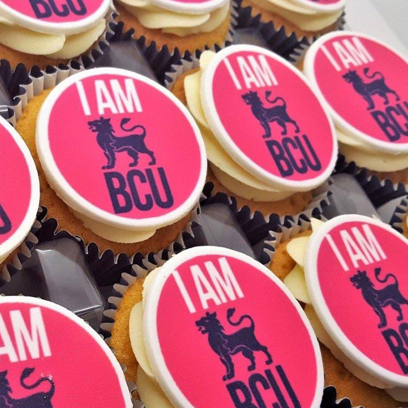 Branded cupcakes with a logo printed on the top
