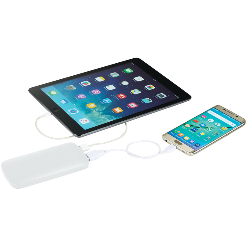 Power bank charging a mobile phone and tablet