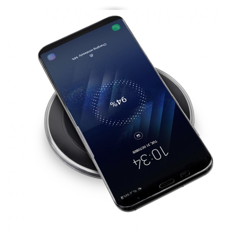 black charging pad topping up a mobile phones battery