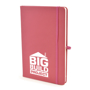 A5 soft touch notebook in pink with colour match ribbon, elastic closure strap and pen loop with 1 colour white print logo