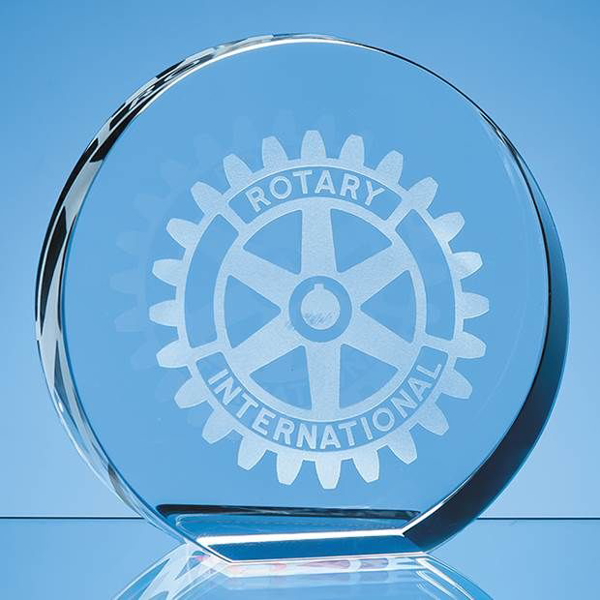 Round crystal paper weight with a graphic engraved on the front