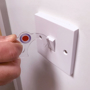 white hygiene hook turning on light switch