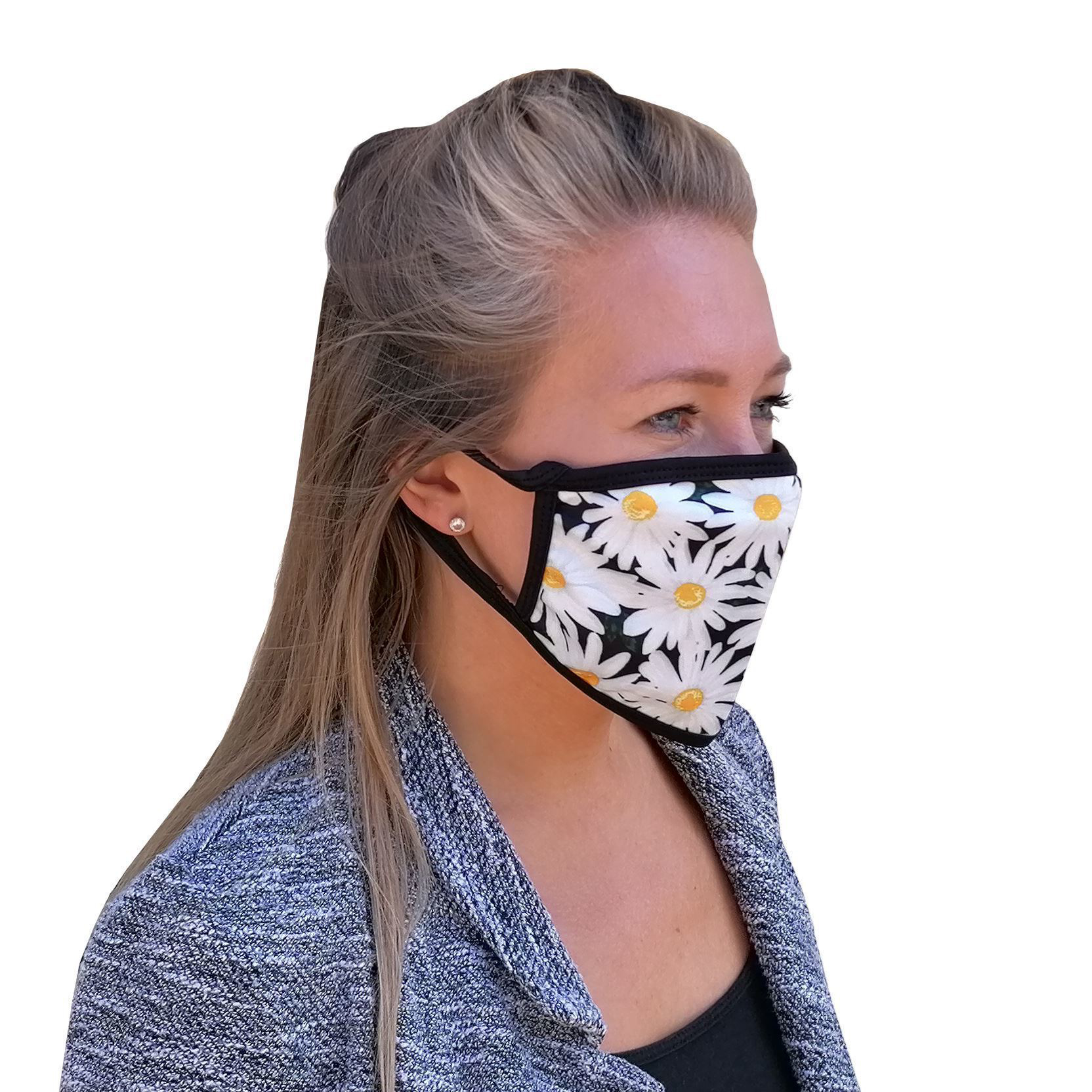 a woman wearing  a face mask with a daisy print