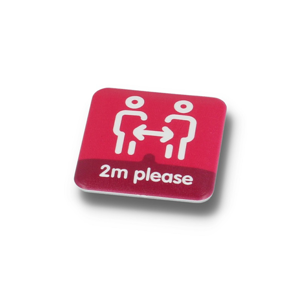 a pink square badge promoting social distancing