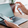 a small spray hand sanitiser in use spraying phone