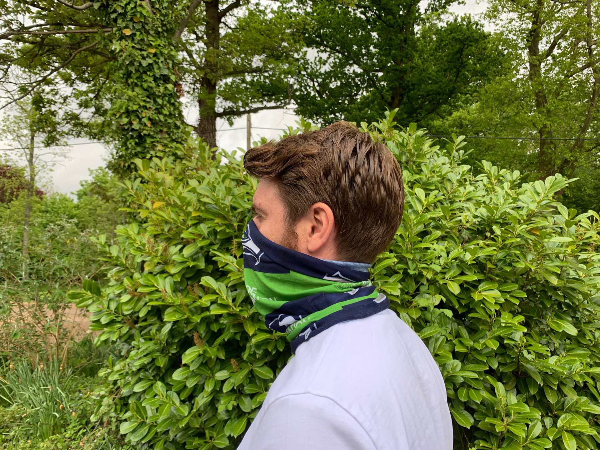 man wearing full colour printed snood with all over daisy design