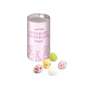 a pink card tube with easter branding next to loose chocolate speckled eggs