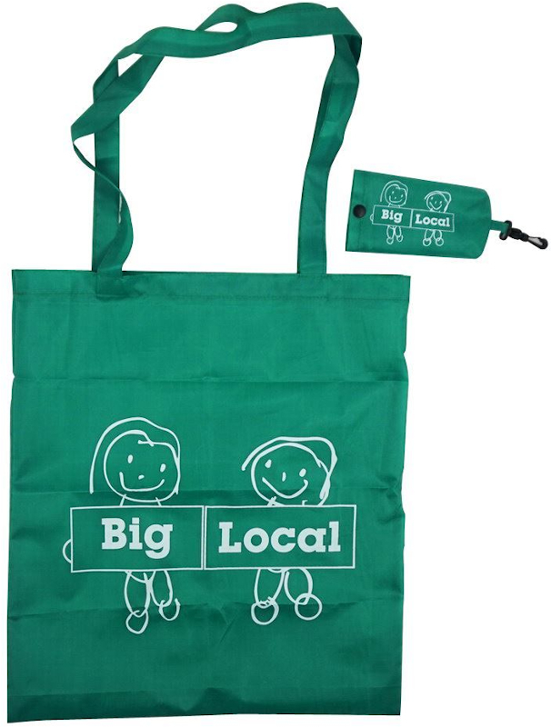 Green long handled foldable shopping bag with storage pouch, both branded with a company logo.