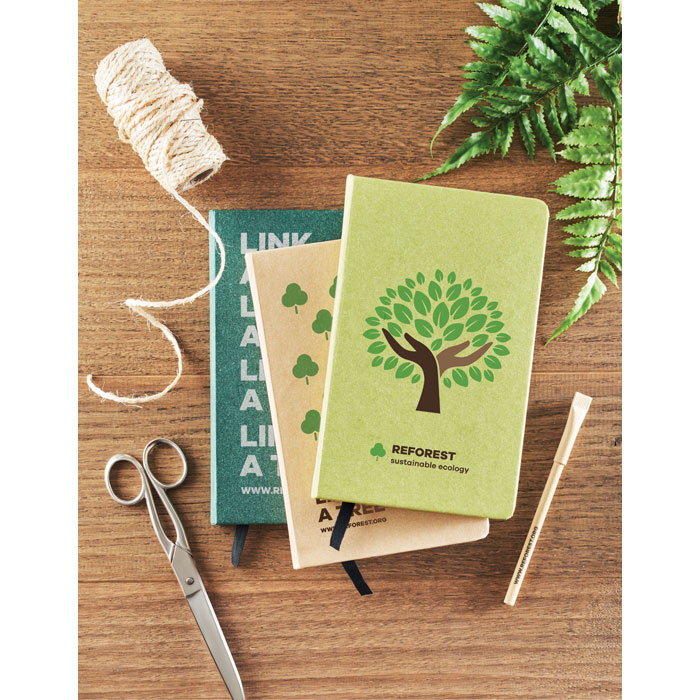 Sustainable Notebook on table amongst other items