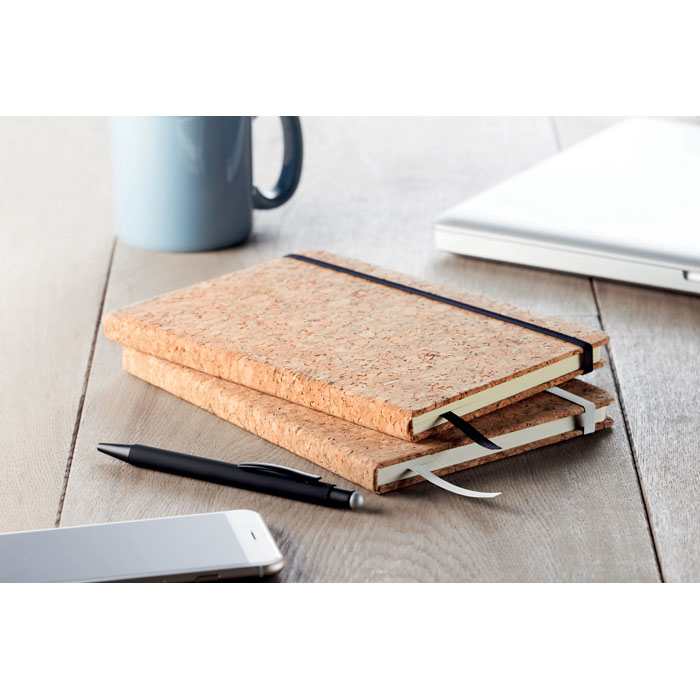 A5 Notebook Hard Cork Cover with black closure strap on table