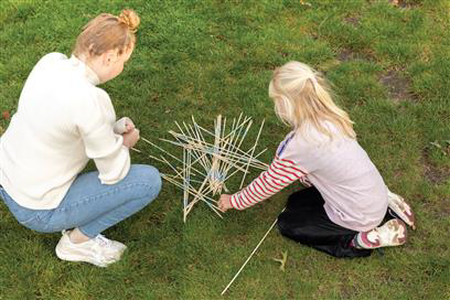 Giant Mikado Set being used and played with in a garden