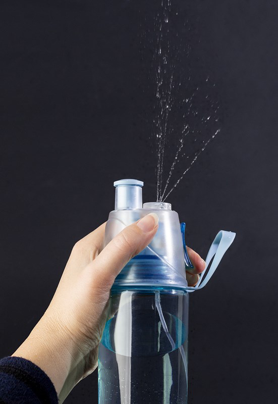 Plastic water bottle with a blue tint, displaying the spray 