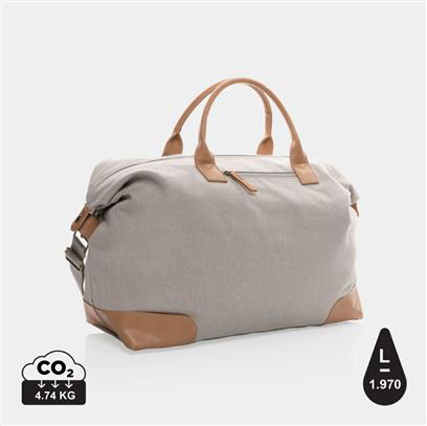 Light grey weekend duffle bag, with light brown handles and patches on the corners 