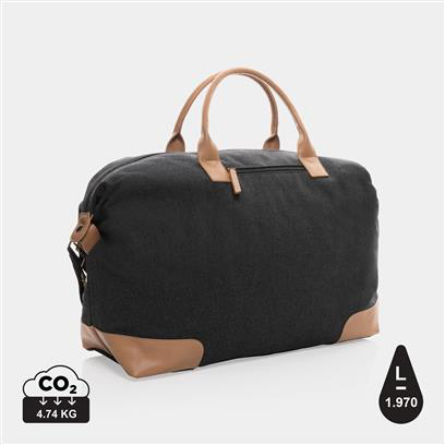black weekend duffle bag, with light brown handles and patches on the corners 
