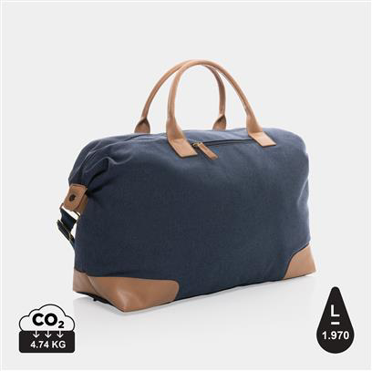 navy weekend duffle bag, with light brown handles and patches on the corners 