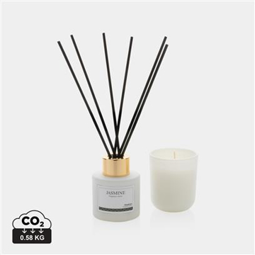 white diffuser with fragrance sticks and a candle 