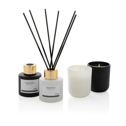white and black diffuser with fragrance sticks and a candle 