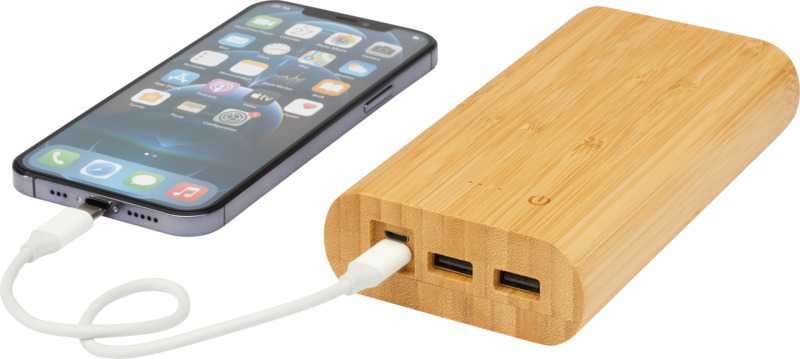 Light brown bamboo powerbank with three charging ports and shown charging a phone