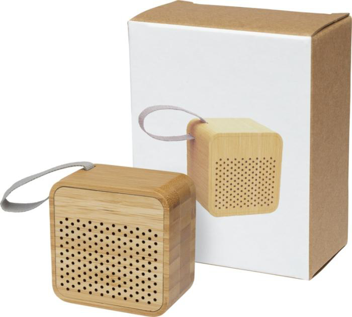 Light brown cube wireless speaker made from bamboo with it's packaging