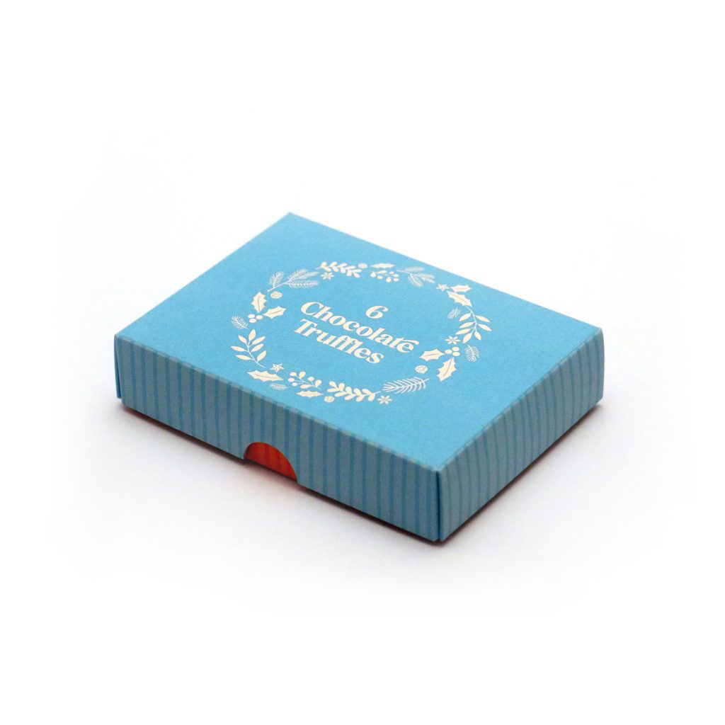 A box of chocolate truffles with the blue lid on