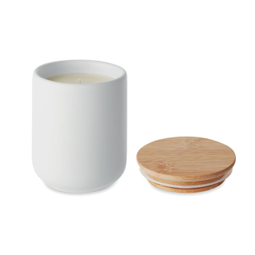 A white candle with light brown lid on the right hand side