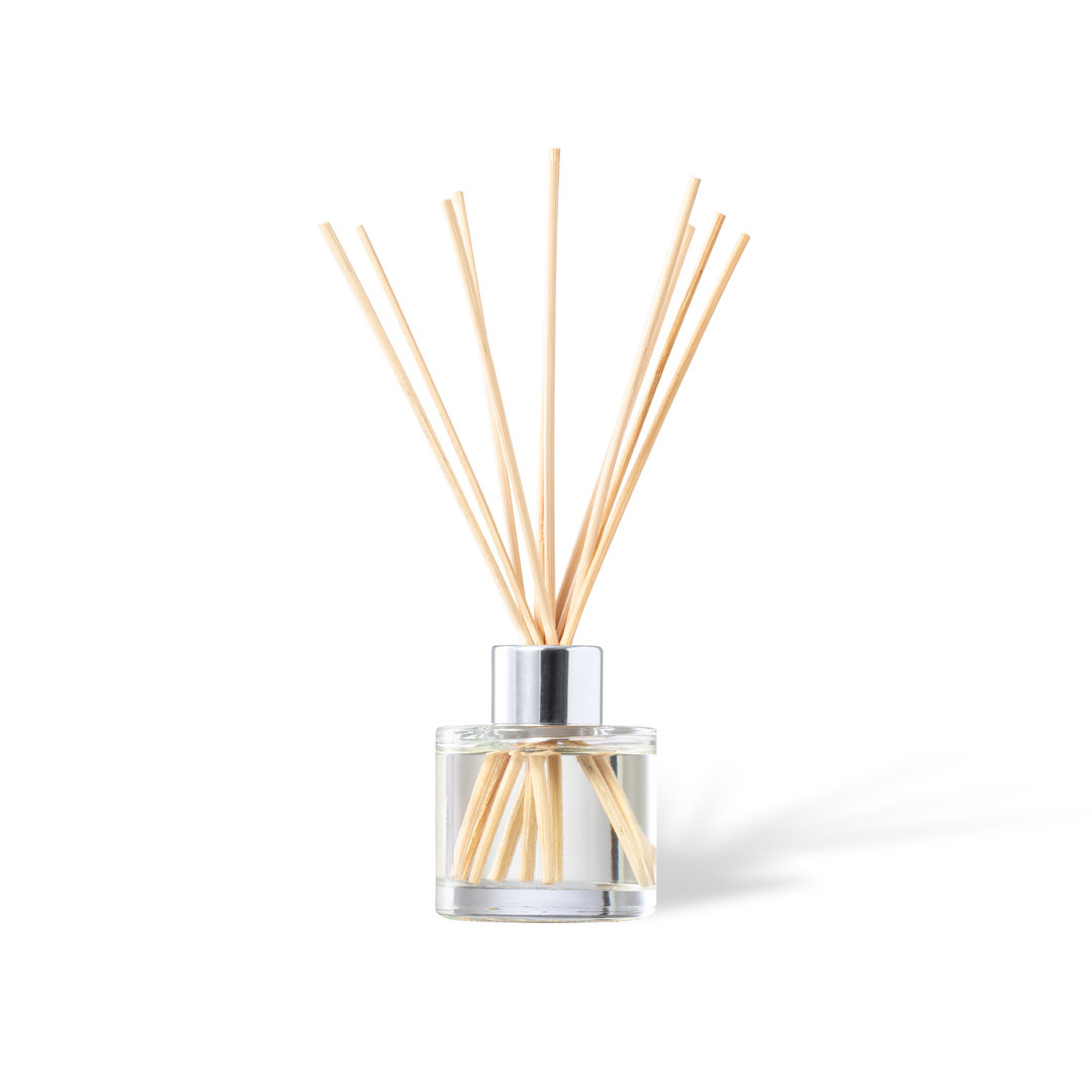 Diffuser with clear jar and light brown fragrance sticks