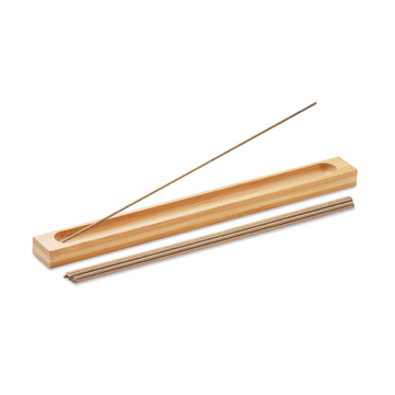 a light brown rectangular bamboo holder with incense sticks